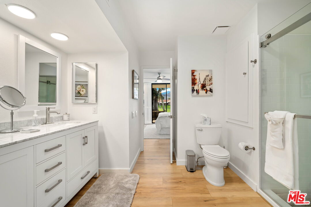 60 La Ronda Drive Rancho Mirage, CA 92270 - Photo 19 of 57 a spacious bathroom with a granite countertop sink toilet and shower