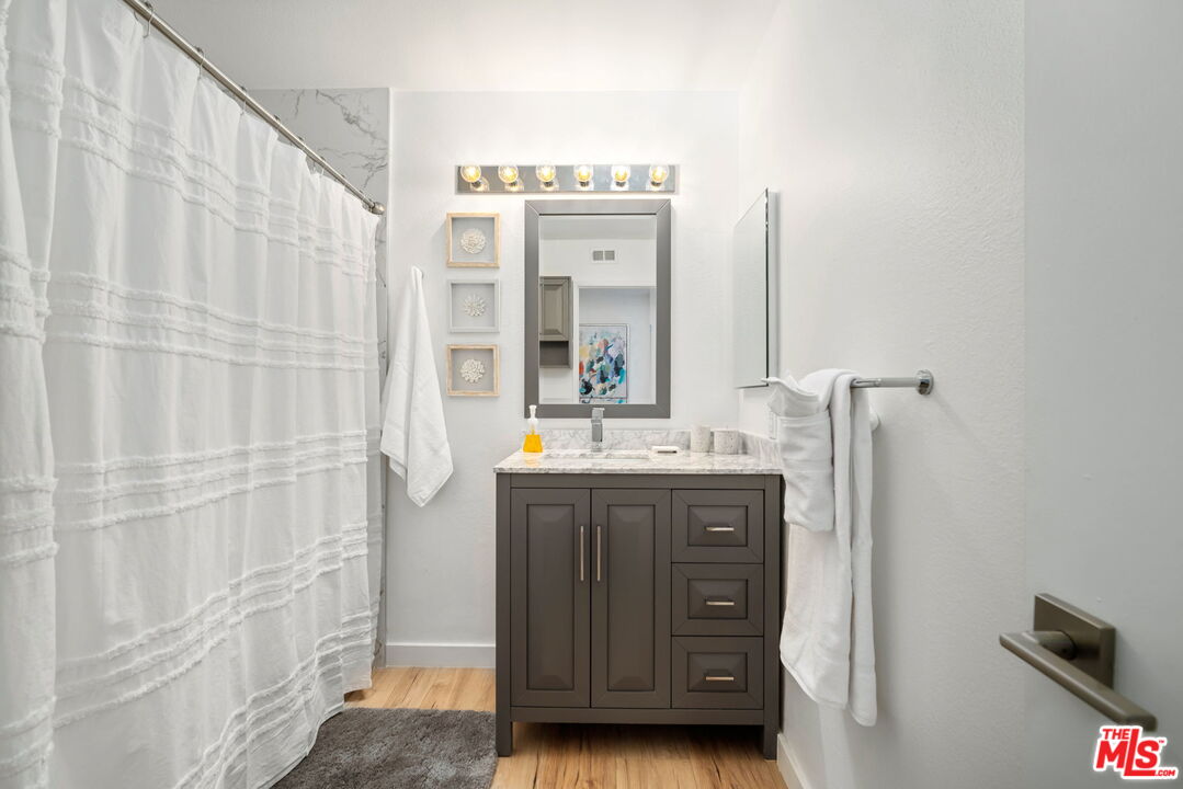 60 La Ronda Drive Rancho Mirage, CA 92270 - Photo 21 of 57 a bathroom with a double vanity sink and mirror