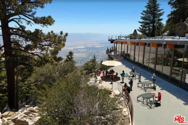 a view of a patio with table and chairs and potted plants