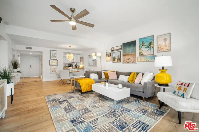 a living room with furniture and kitchen view
