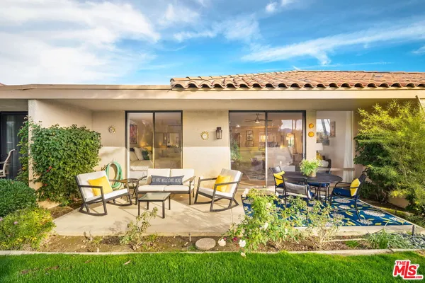 a front view of a house with a yard table and chairs