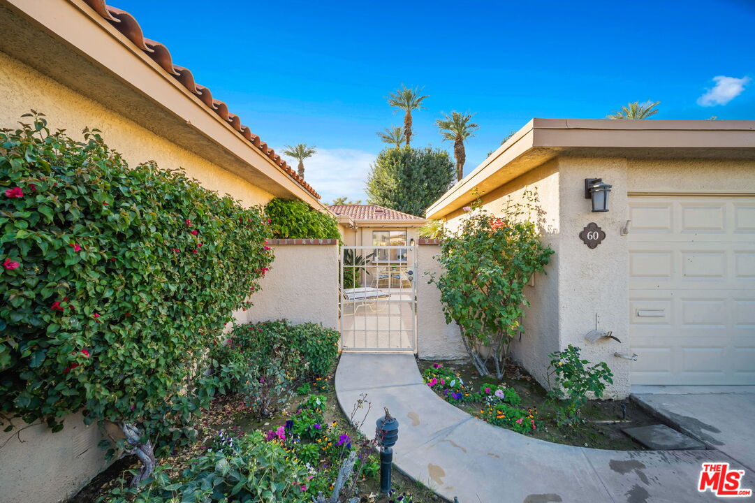 60 La Ronda Drive Rancho Mirage, CA 92270 - Photo 49 of 57 a front view of a house with garden