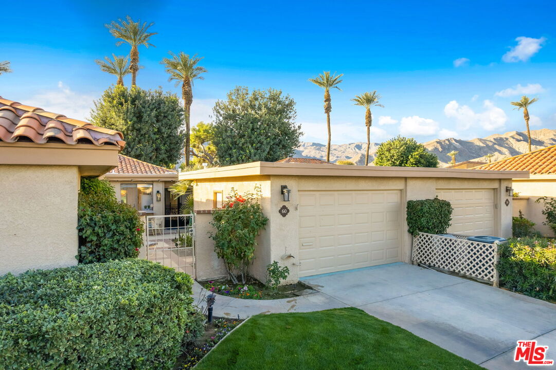 60 La Ronda Drive Rancho Mirage, CA 92270 - Photo 50 of 57 a view of a house with a yard and potted plants