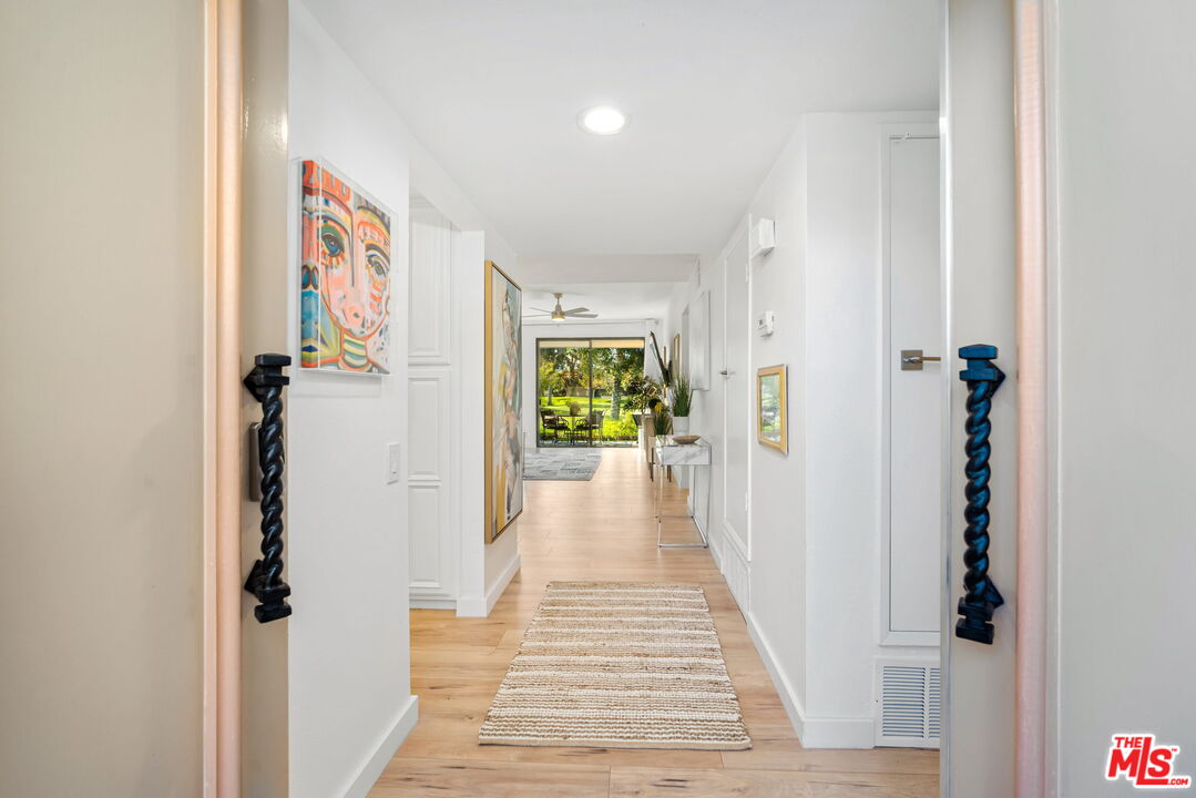 60 La Ronda Drive Rancho Mirage, CA 92270 - Photo 6 of 57 a view of a hallway with wooden floor and staircase