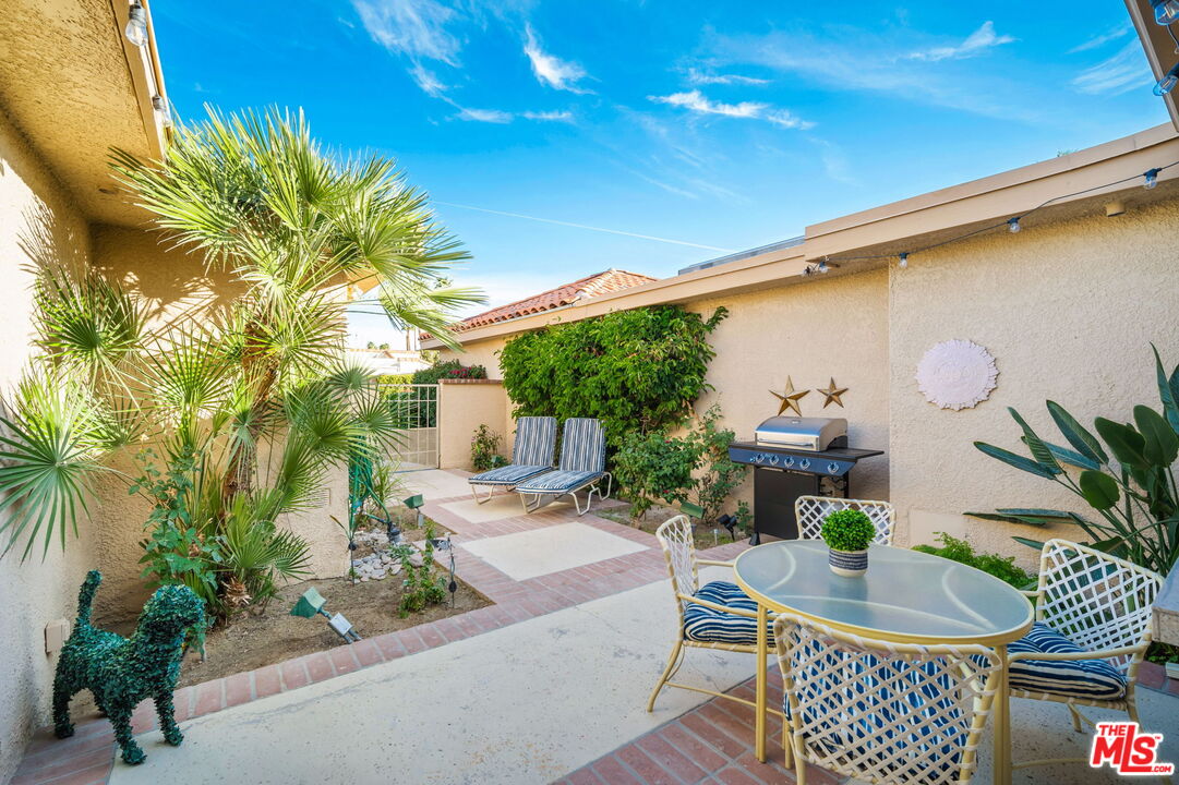 60 La Ronda Drive Rancho Mirage, CA 92270 - Photo 7 of 57 a backyard of a house with table and chairs