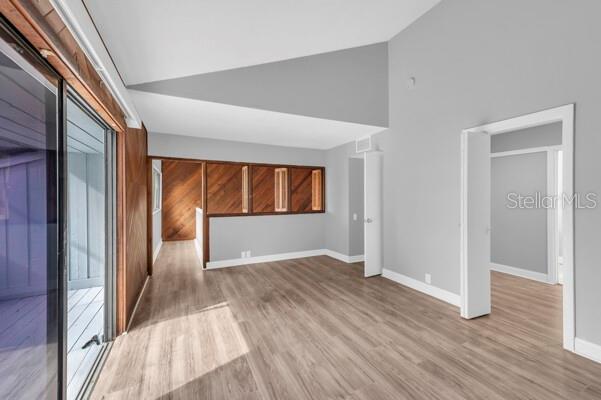 1502 Lake Buckeye Road, Unit 2 Winter Haven, FL 33881 - Photo 27 of 47 wooden floor in an empty room with a window
