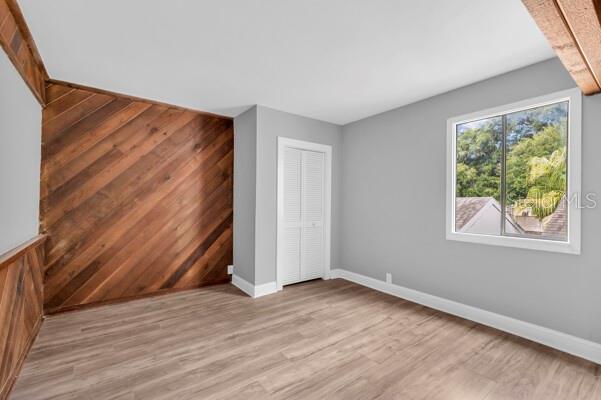 1502 Lake Buckeye Road, Unit 2 Winter Haven, FL 33881 - Photo 28 of 47 a view of an empty room with wooden floor and a window