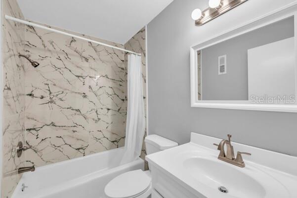 1502 Lake Buckeye Road, Unit 2 Winter Haven, FL 33881 - Photo 30 of 47 a bathroom with a sink toilet and shower