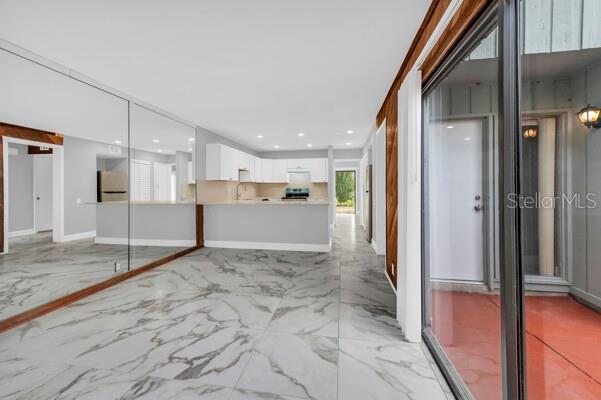 1502 Lake Buckeye Road, Unit 2 Winter Haven, FL 33881 - Photo 5 of 47 a view of a hallway with wooden floors and kitchen view