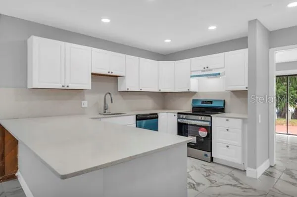 a kitchen with white cabinets sink and white appliances