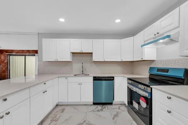 a white refrigerator freezer and a wooden floor