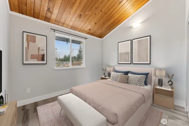 a bedroom with a bed and a tv