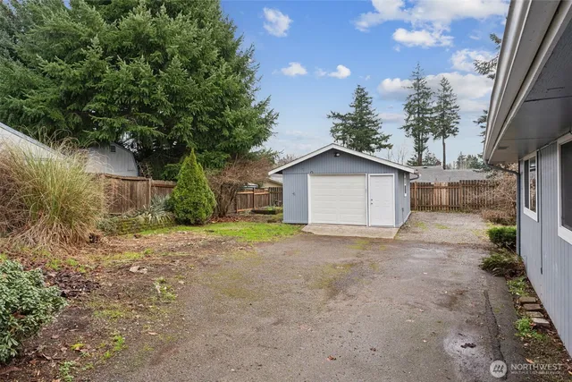 a view of backyard of house with green space