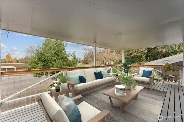 a bedroom with a balcony a bed and a flat screen tv