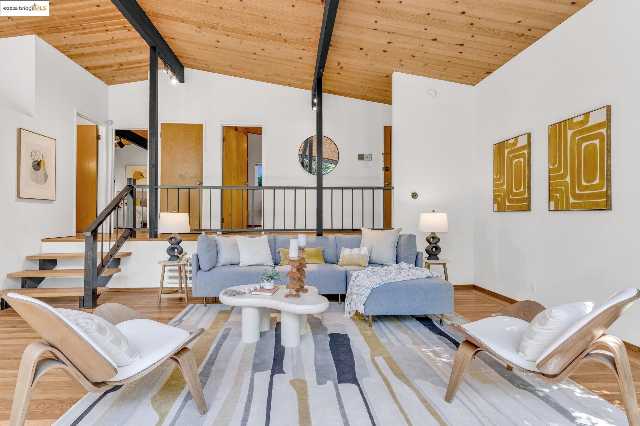 2211 Arrowhead Drive Oakland, CA 94611 - Photo 16 of 52 Living room with a wooden ceiling with exposed beams, wood finished floors, high vaulted ceiling, and stairway