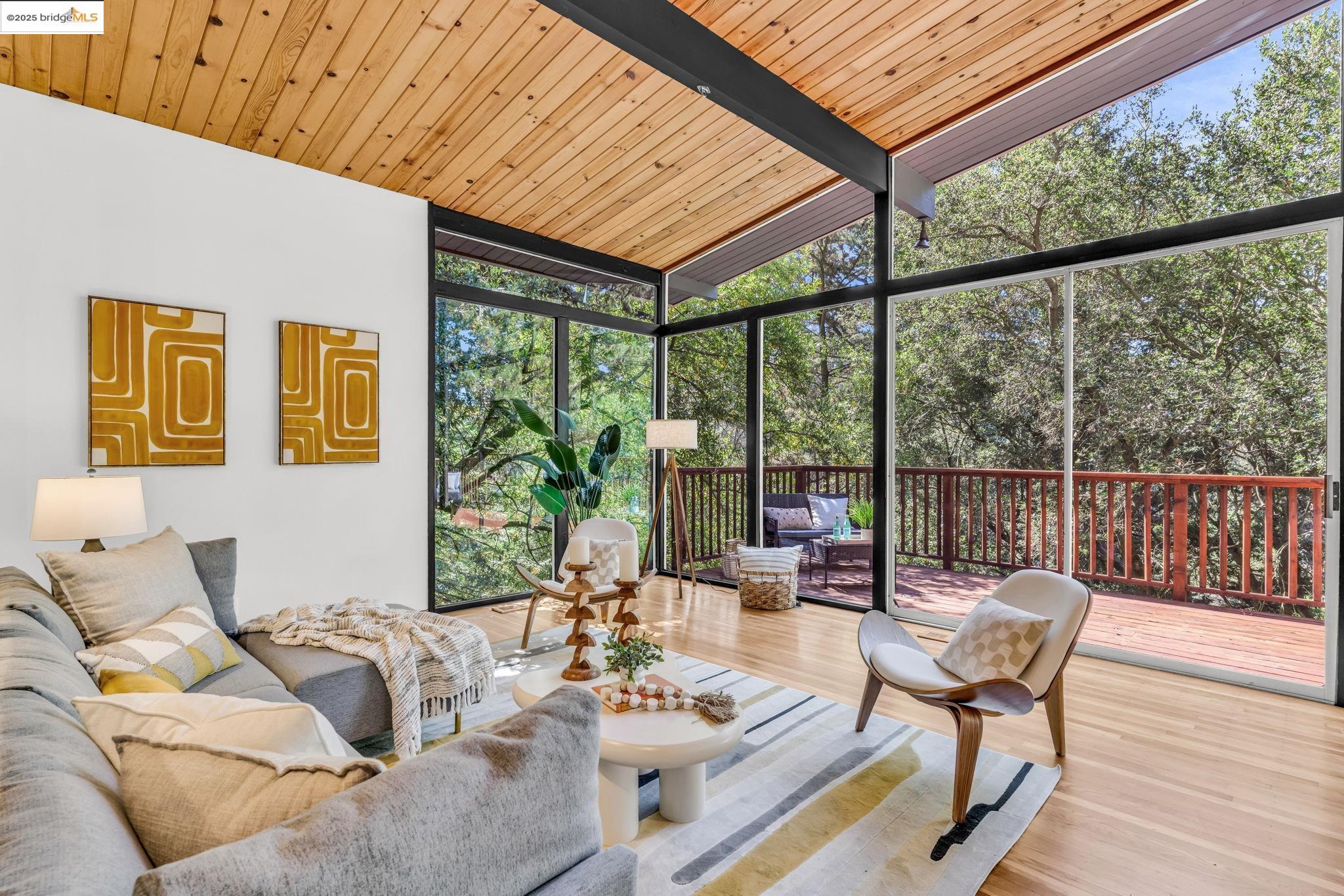 2211 Arrowhead Drive Oakland, CA 94611 - Photo 17 of 52 Living area with expansive windows, wood finished floors, and wooden ceiling