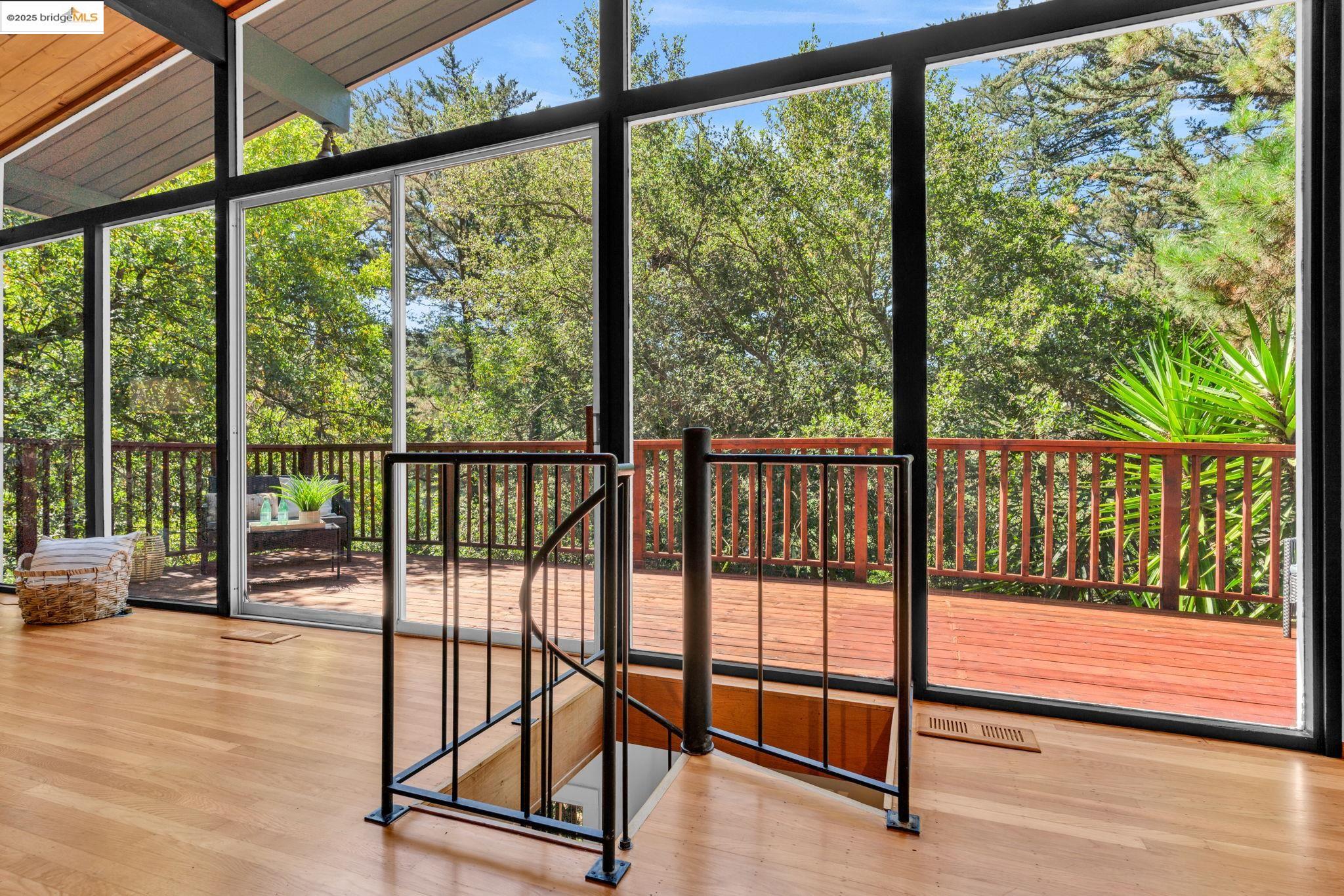 2211 Arrowhead Drive Oakland, CA 94611 - Photo 19 of 52 Unfurnished sunroom with vaulted ceiling and view of wooded area