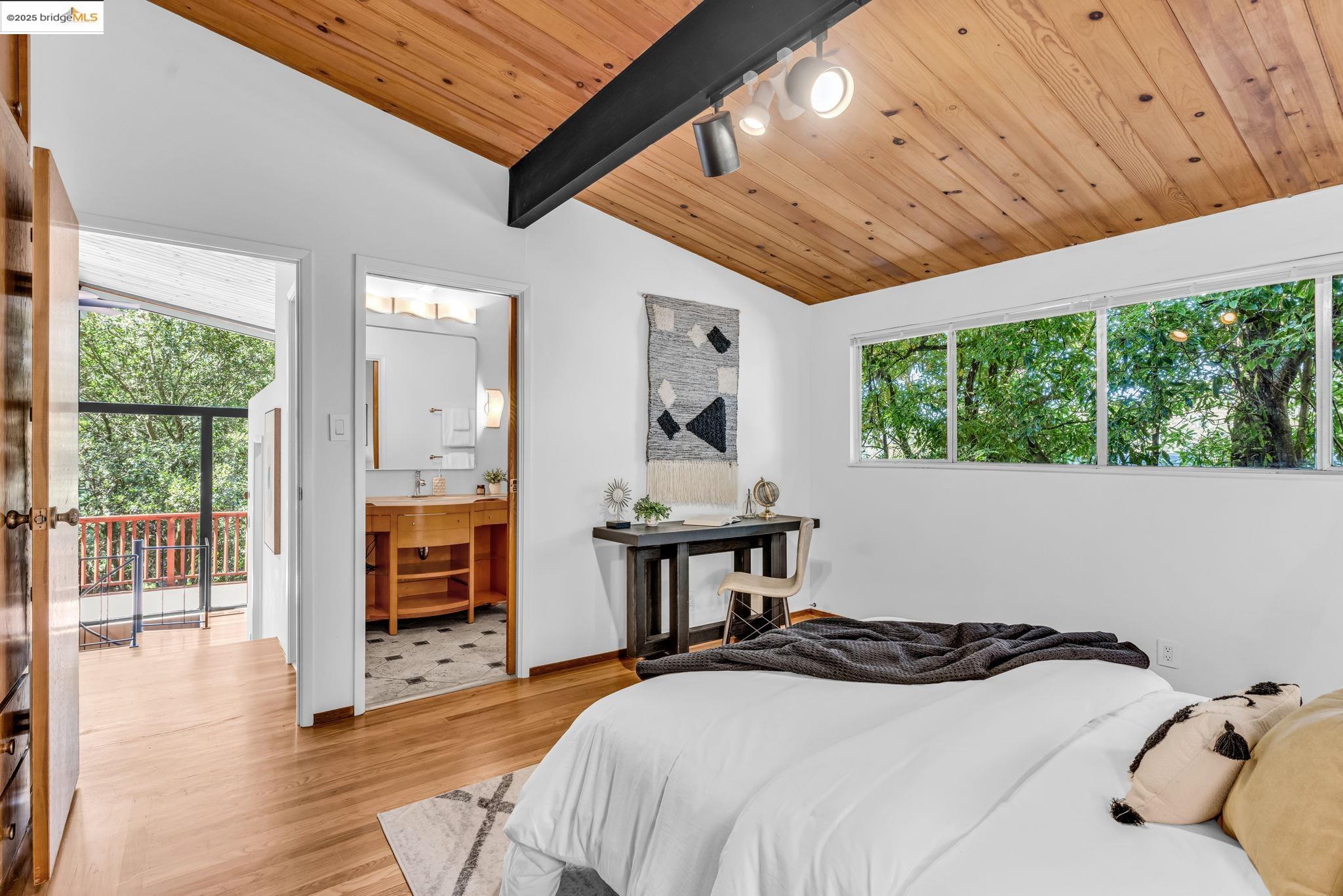 2211 Arrowhead Drive Oakland, CA 94611 - Photo 30 of 52 Bedroom featuring light wood finished floors, multiple windows, wooden ceiling, and ensuite bathroom