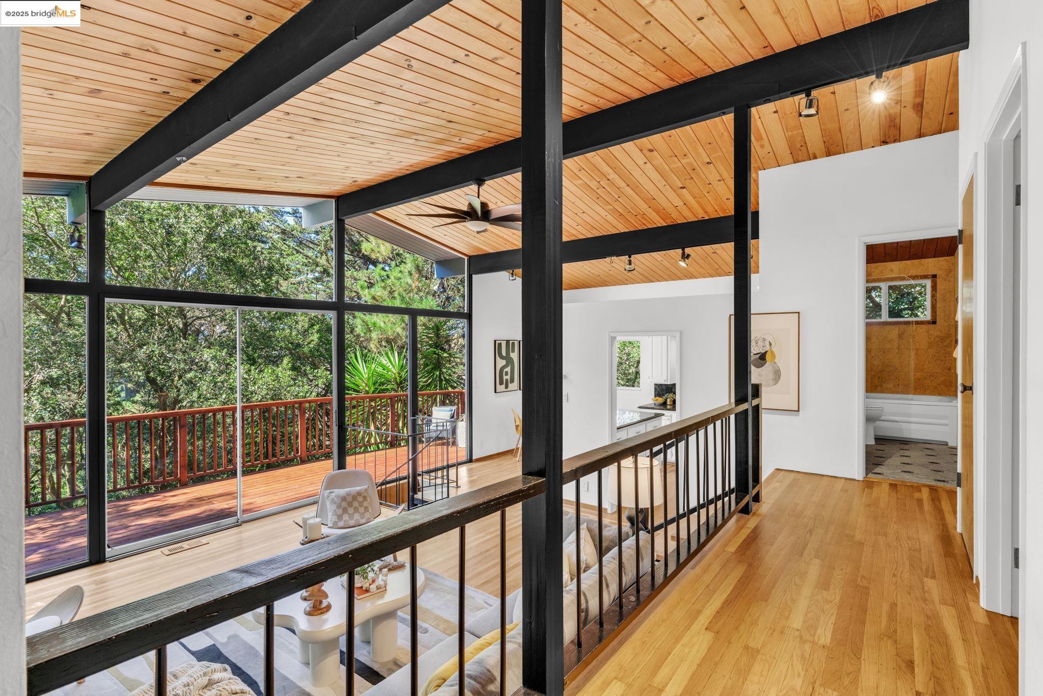 2211 Arrowhead Drive Oakland, CA 94611 - Photo 6 of 52 Corridor with light wood-style flooring, track lighting, wooden ceiling, and floor to ceiling windows
