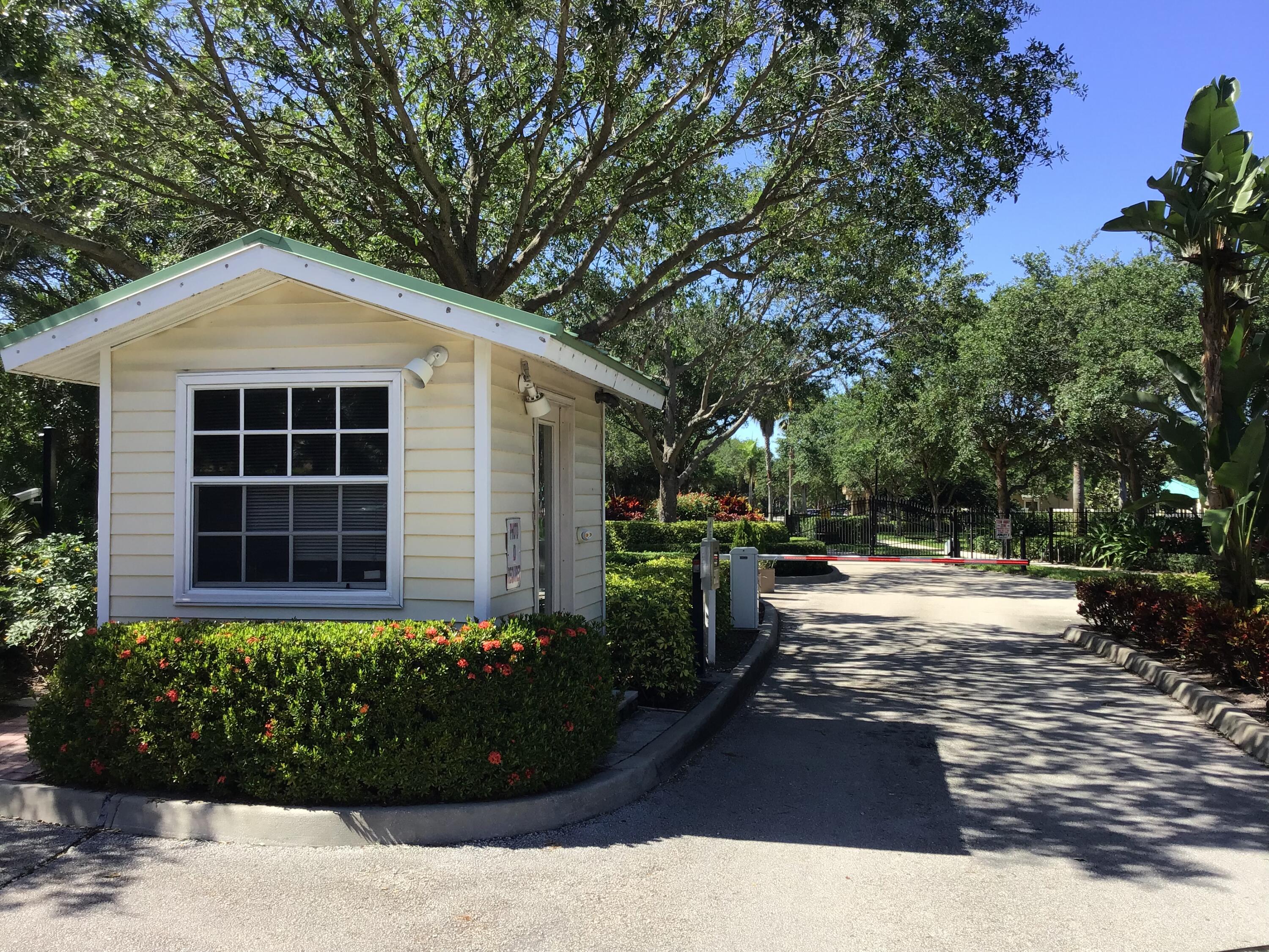 2753 Southeast Birmingham Drive Stuart, FL 34994 - Photo 20 of 22 a view of a backyard with potted plants and large trees