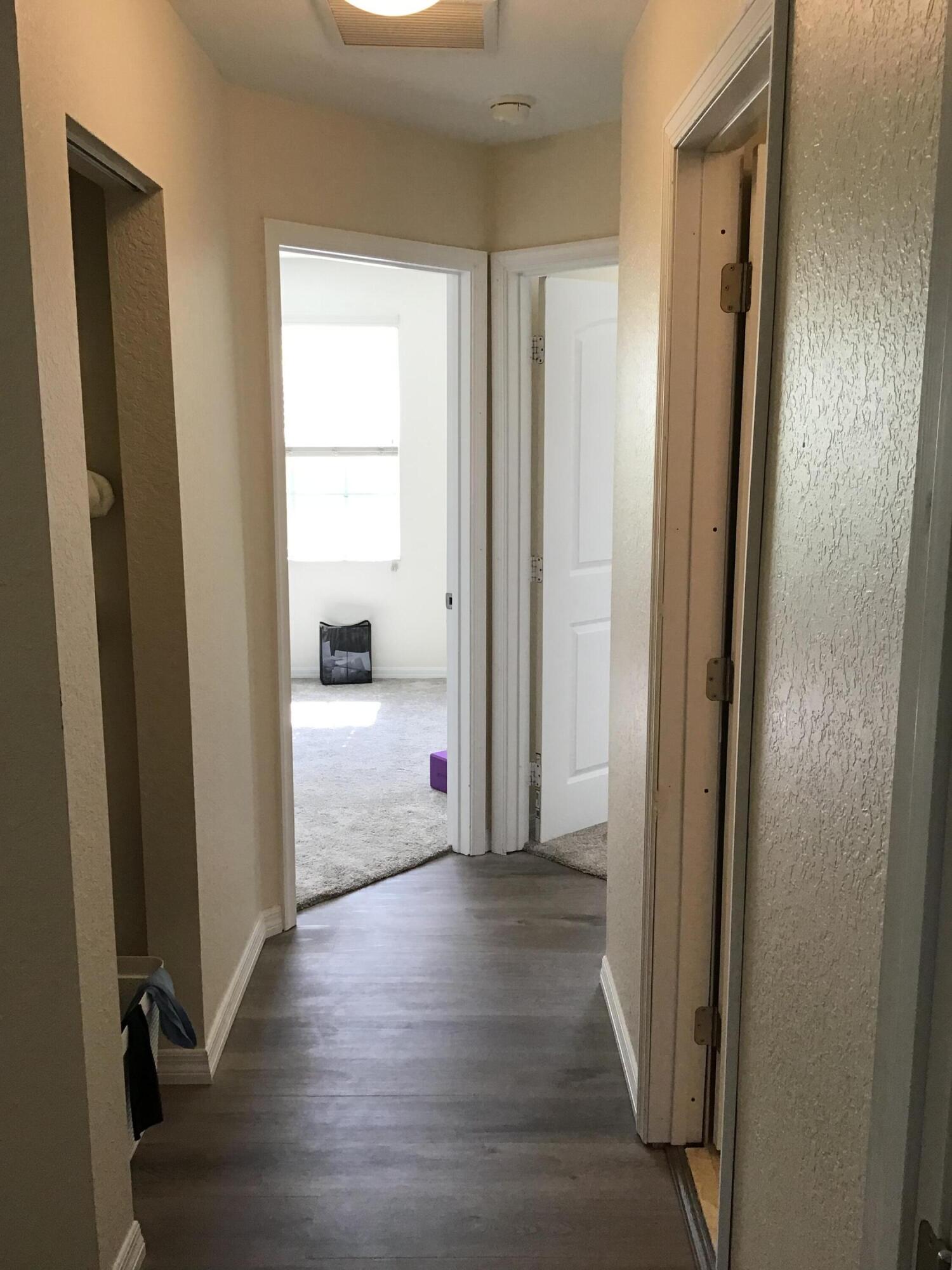 2753 Southeast Birmingham Drive Stuart, FL 34994 - Photo 10 of 22 a view of a hallway with wooden floor