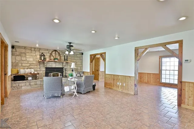 a living room with furniture a fireplace and gym equipment