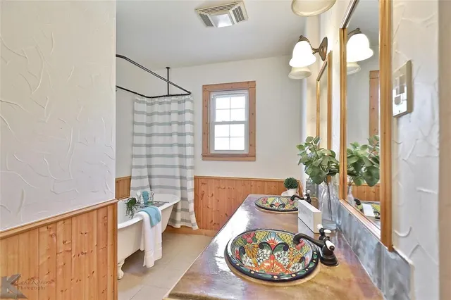 a view of a bedroom with a bed and a potted plant