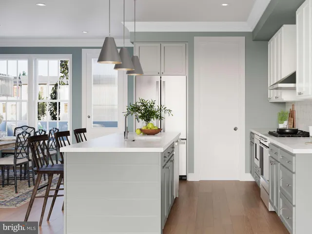 a kitchen with stainless steel appliances a table and a chandelier