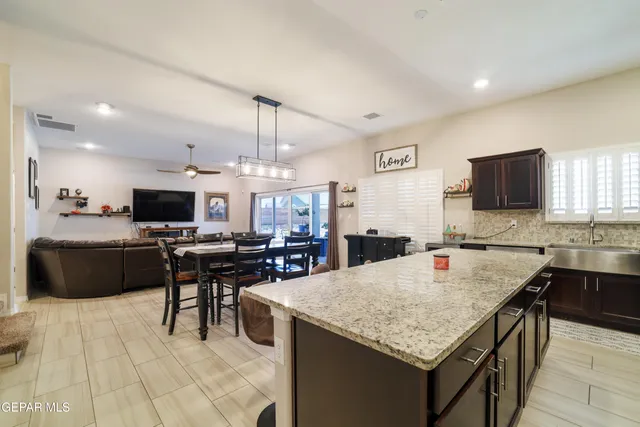 a kitchen with stainless steel appliances granite countertop a sink and a stove