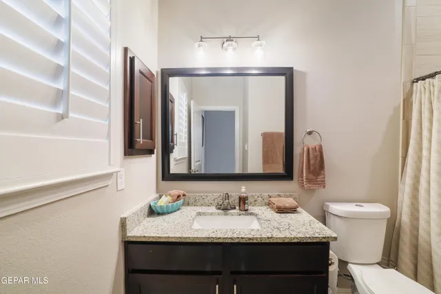 a room with a bed and a flat screen tv with wooden floor
