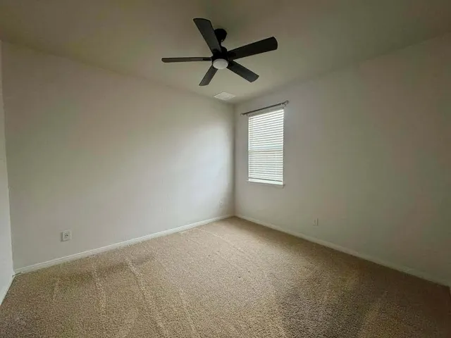 a kitchen with stainless steel appliances granite countertop a sink a oven a refrigerator and white cabinets