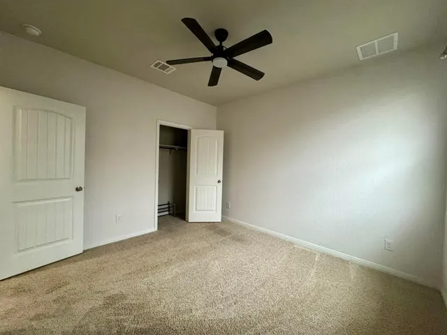 a kitchen with stainless steel appliances granite countertop a sink a stove a refrigerator and island with wooden floor