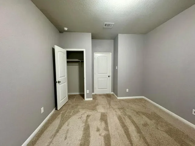 a bathroom with a granite countertop sink a mirror and a shower