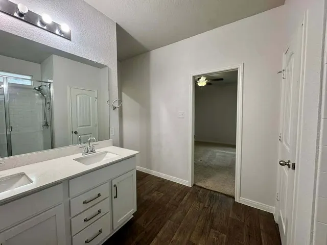 a view of walk in closet with empty racks
