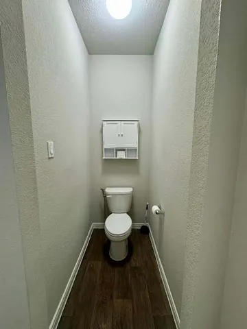 a house view with a garden space and wooden fence