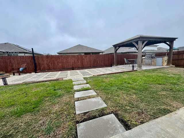 a view of yard with patio