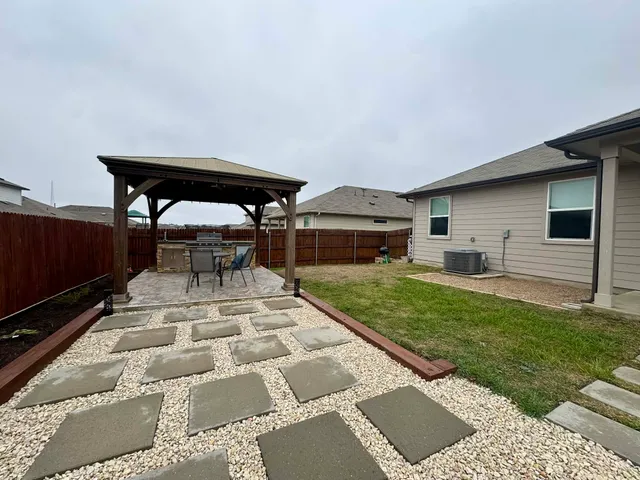 a view of yard with patio