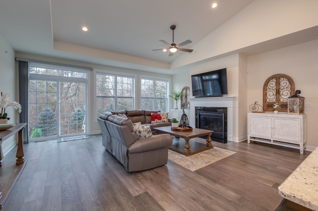 3 Hummingbird Way, Unit 3 Methuen, MA 01844 - Photo 12 of 36 a living room with furniture a fireplace and a flat screen tv