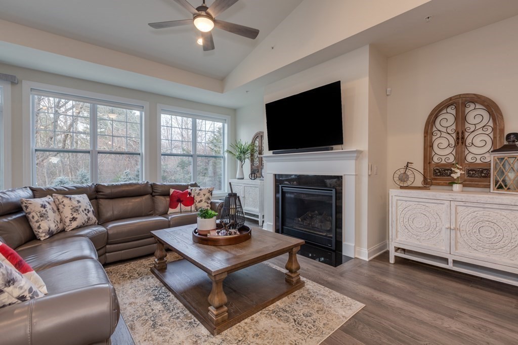 3 Hummingbird Way, Unit 3 Methuen, MA 01844 - Photo 13 of 36 a living room with furniture a fireplace and a flat screen tv