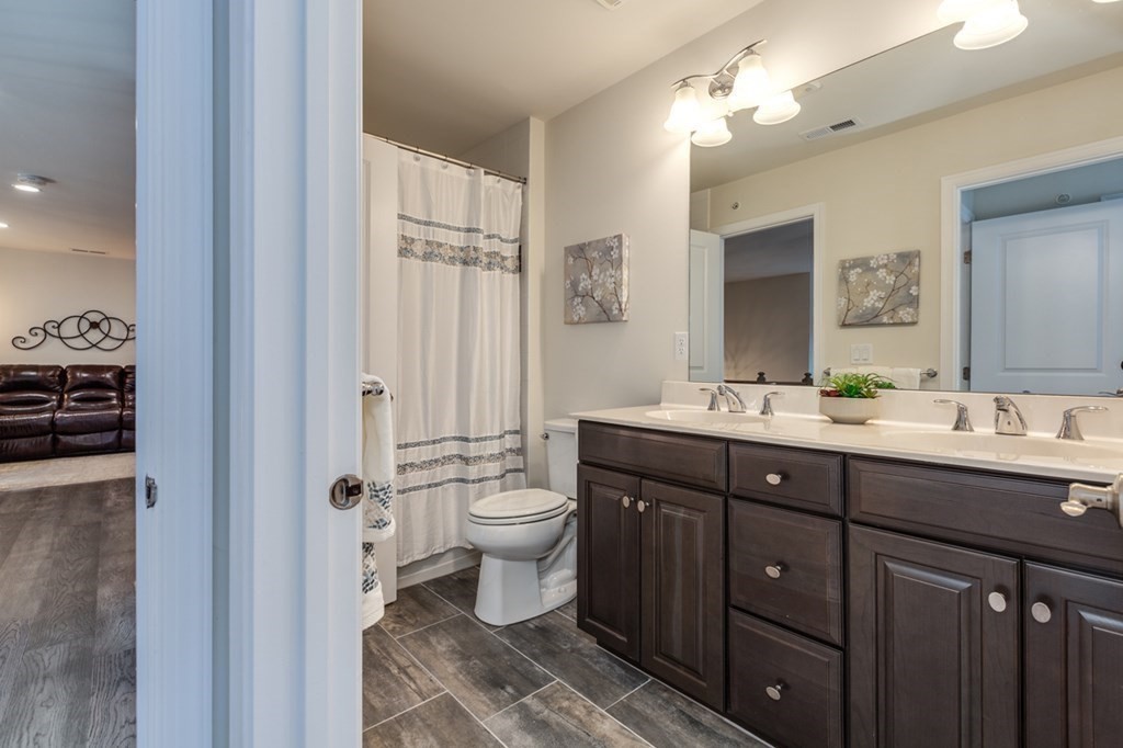 3 Hummingbird Way, Unit 3 Methuen, MA 01844 - Photo 25 of 36 a bath room with a sink vanity granite and a toilet