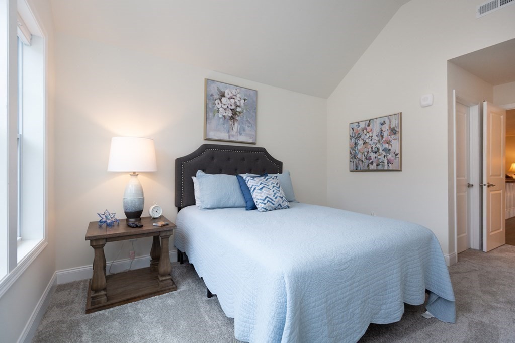 3 Hummingbird Way, Unit 3 Methuen, MA 01844 - Photo 26 of 36 a bedroom with a bed and a lamp on table