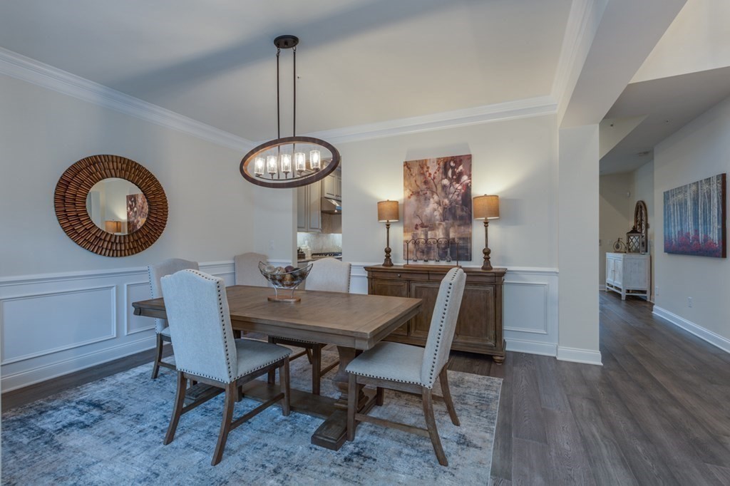 3 Hummingbird Way, Unit 3 Methuen, MA 01844 - Photo 3 of 36 a dining room with wooden floor a chandelier a wooden table and chairs