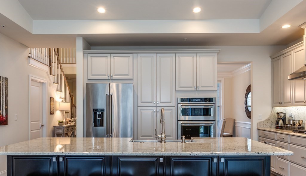 3 Hummingbird Way, Unit 3 Methuen, MA 01844 - Photo 8 of 36 a kitchen with stainless steel appliances kitchen island granite countertop a refrigerator oven and white cabinets with wooden floor