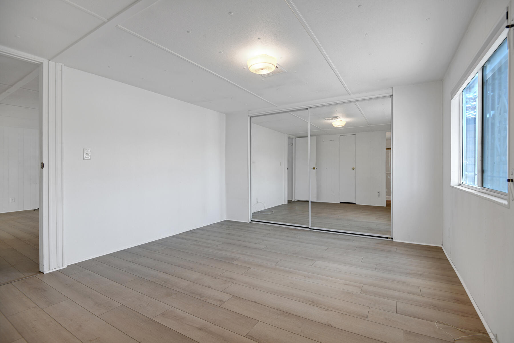 32121 Oakland Hills Street Thousand Palms, CA 92276 - Photo 12 of 20 a view of empty room with wooden floor and fan