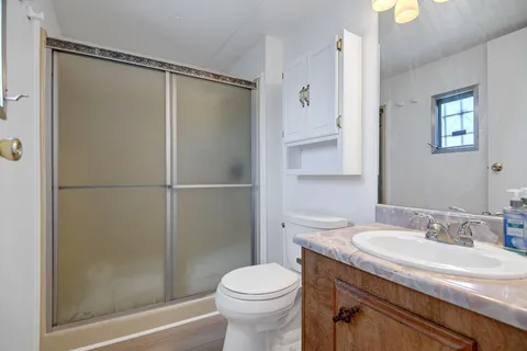 a bathroom with a sink toilet and shower