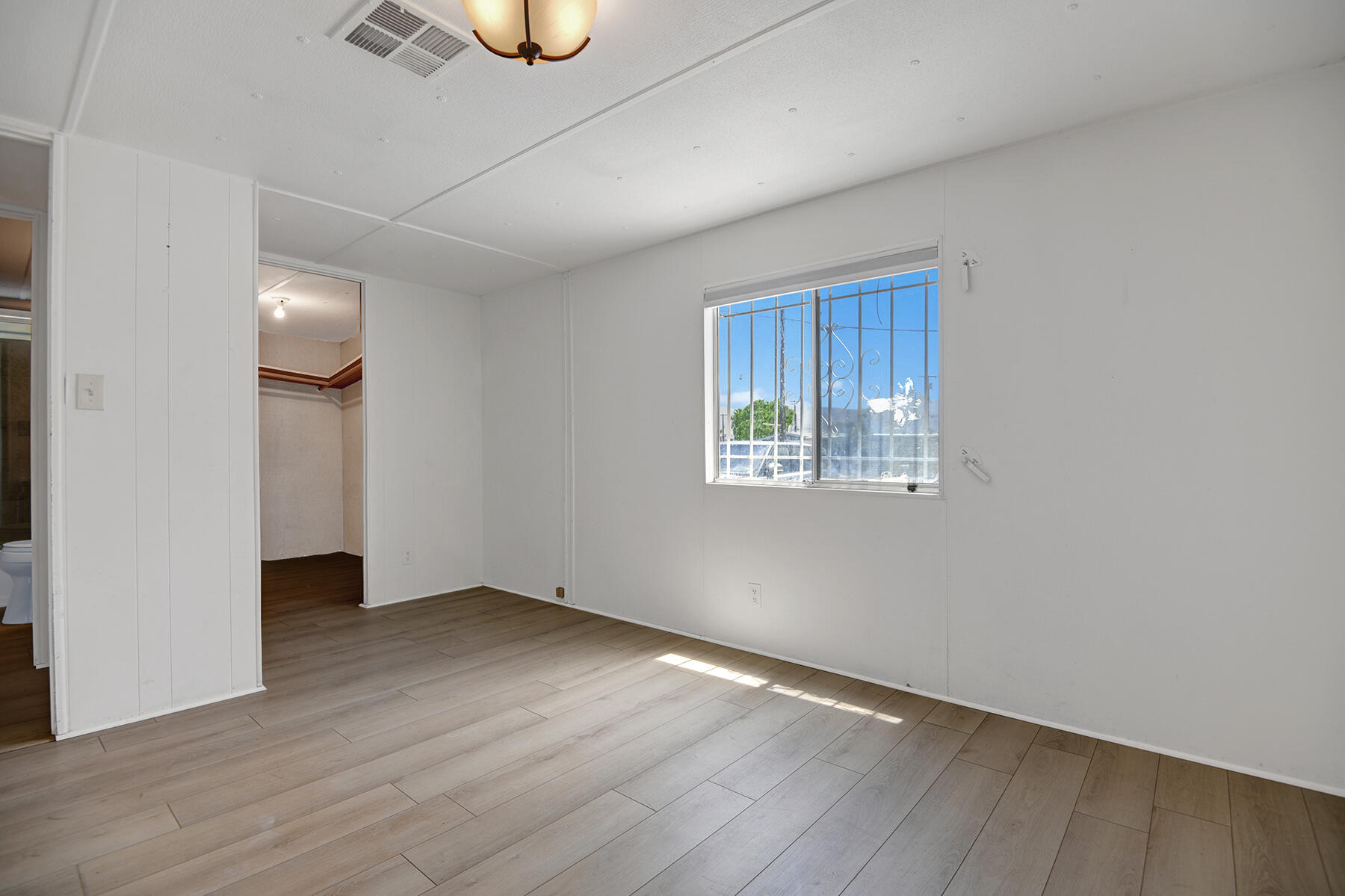 32121 Oakland Hills Street Thousand Palms, CA 92276 - Photo 15 of 20 an empty room with wooden floor and windows