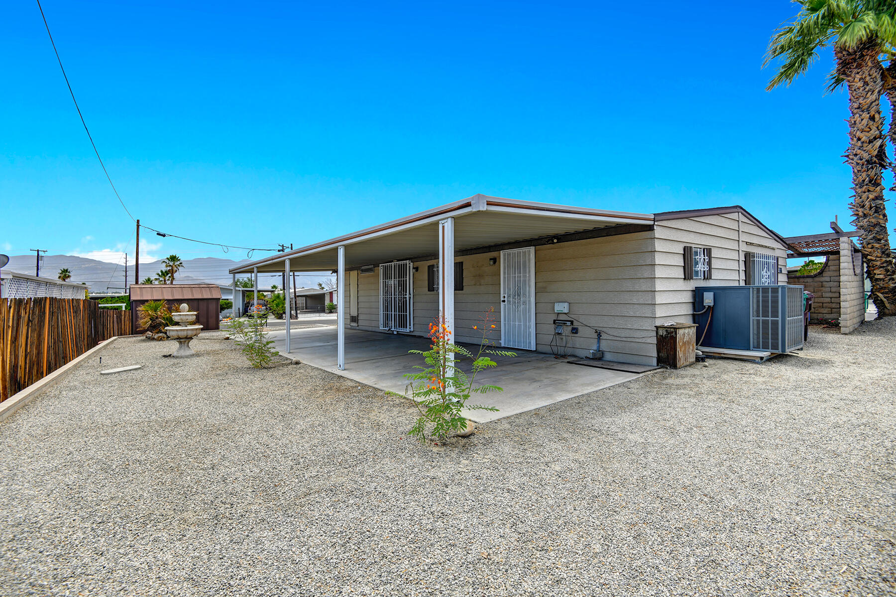 32121 Oakland Hills Street Thousand Palms, CA 92276 - Photo 19 of 20 a view of a house with a backyard