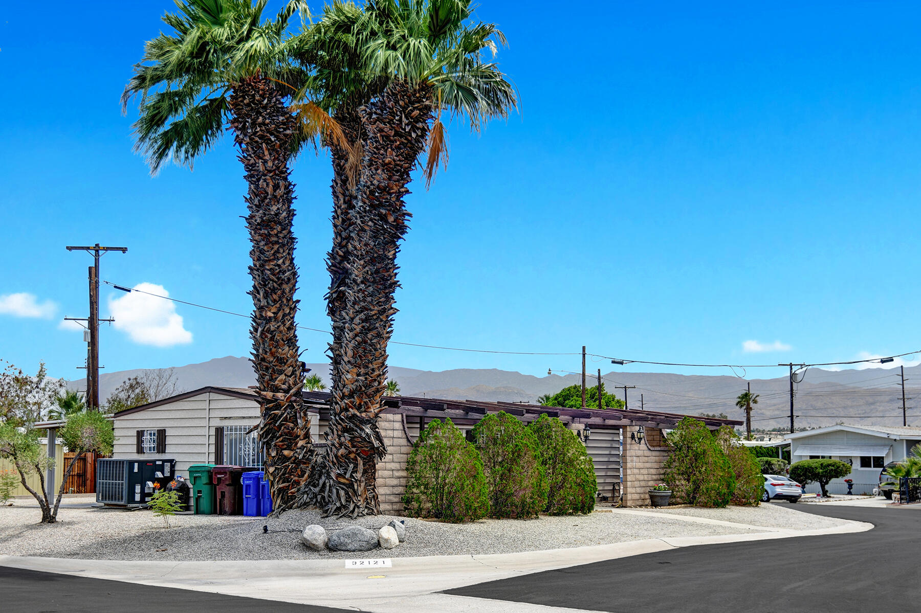 32121 Oakland Hills Street Thousand Palms, CA 92276 - Photo 20 of 20 a view of a street with a cars park side of the road