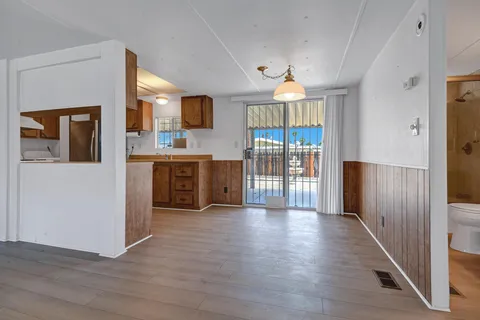 a view of a kitchen with a sink a refrigerator and a fireplace