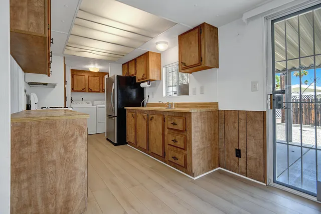 a kitchen with stainless steel appliances granite countertop a refrigerator and a stove